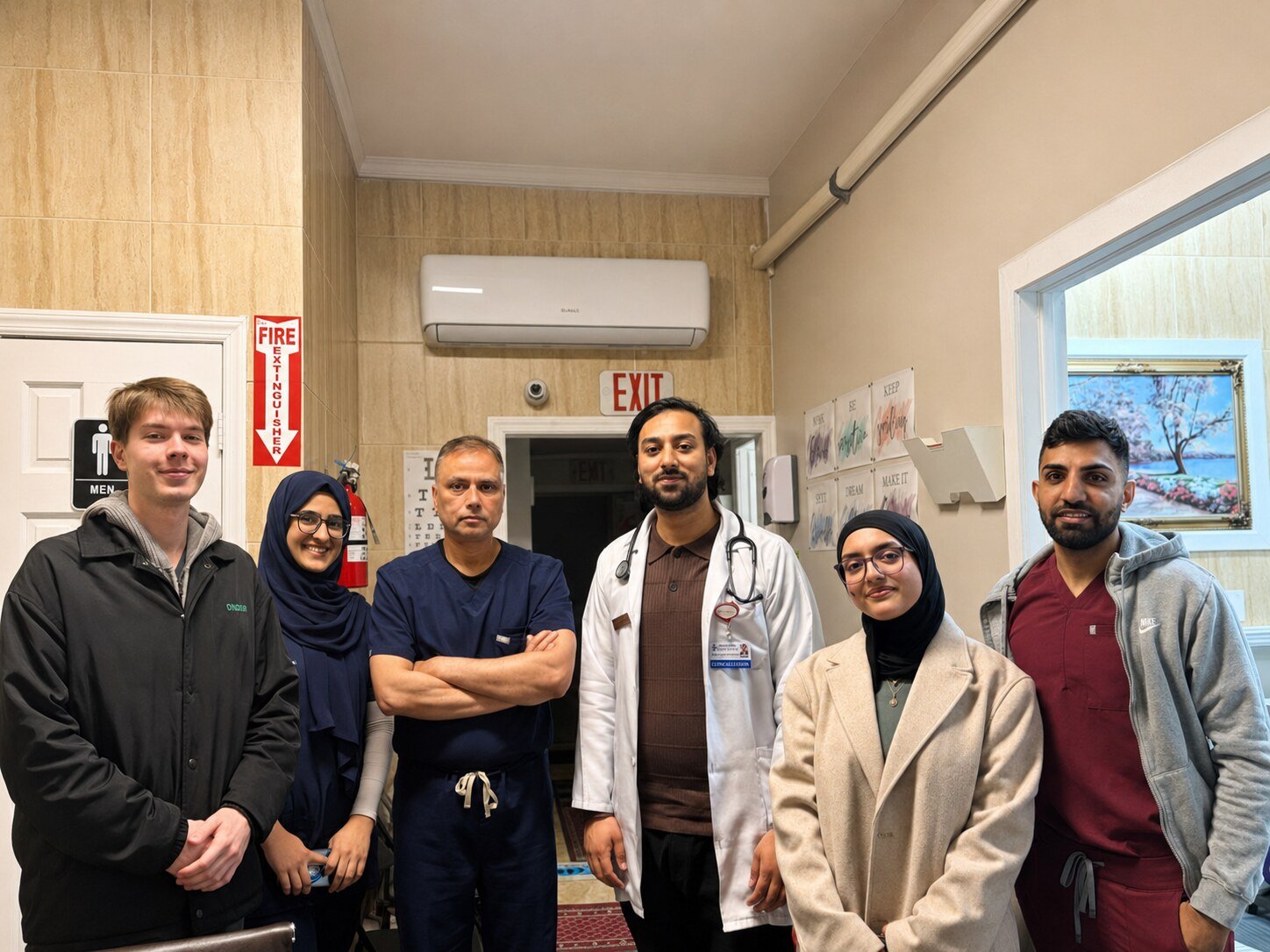 Medical learners and clinicians standing together inside the practice